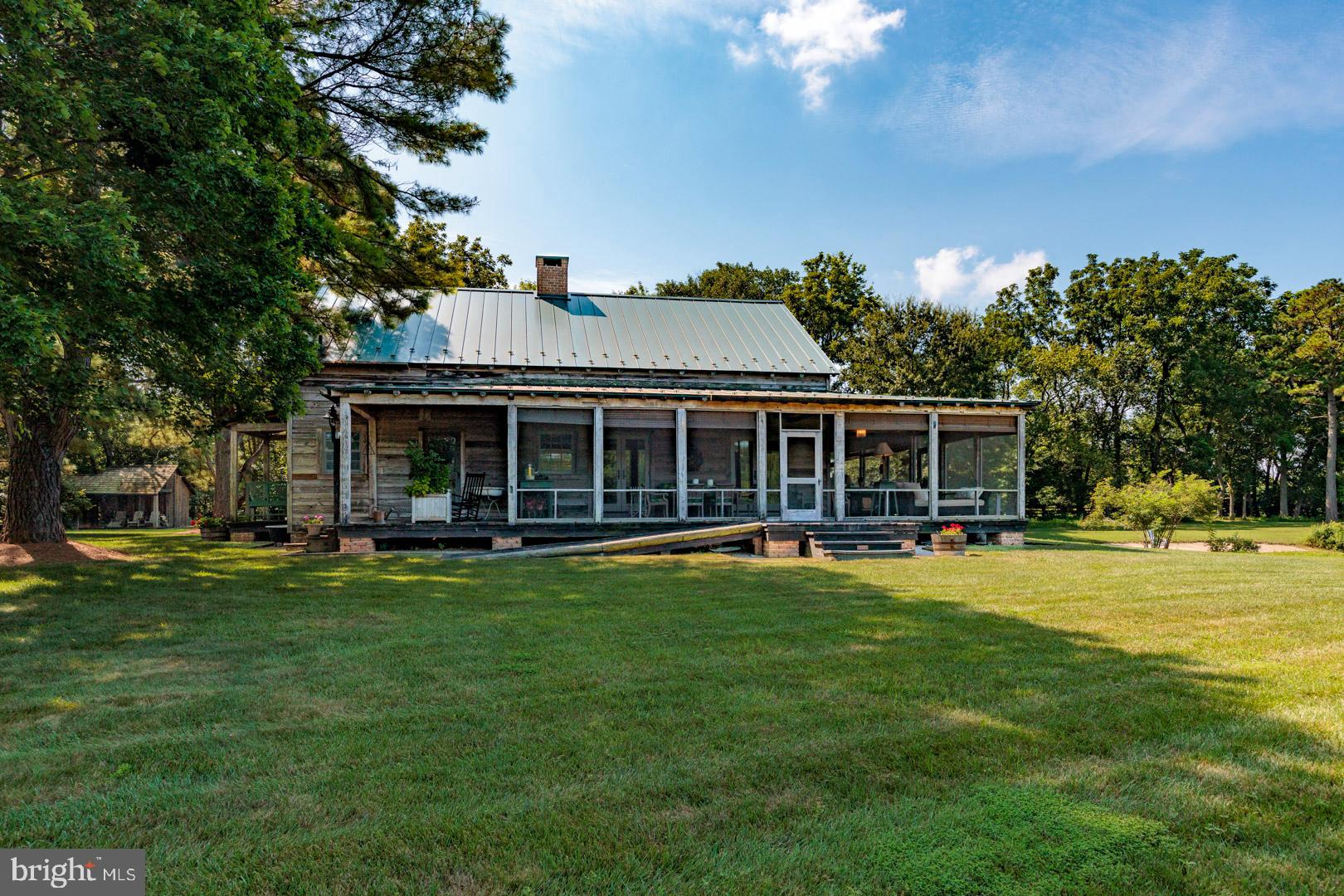 6150 Oxford Road Easton, MD 21601 - Photo 29 of 52 a front view of a house with a garden