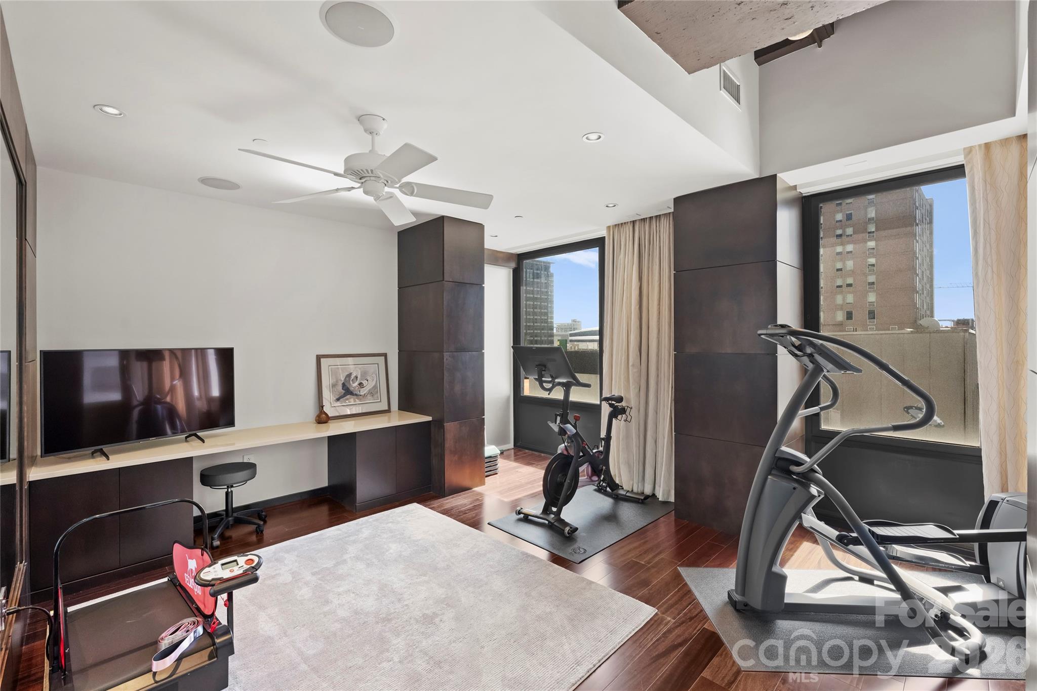 139 South Tryon Street, Unit 6 Charlotte, NC 28202 - Photo 30 of 47 a view of a workspace with furniture and a gym machine