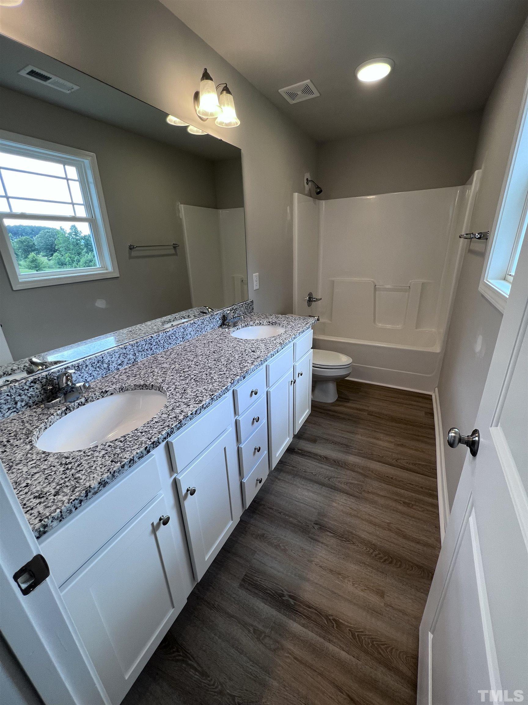 390 Roberts Road Willow Spring, NC 27592 - Photo 12 of 18 a bathroom with a granite countertop sink and a mirror