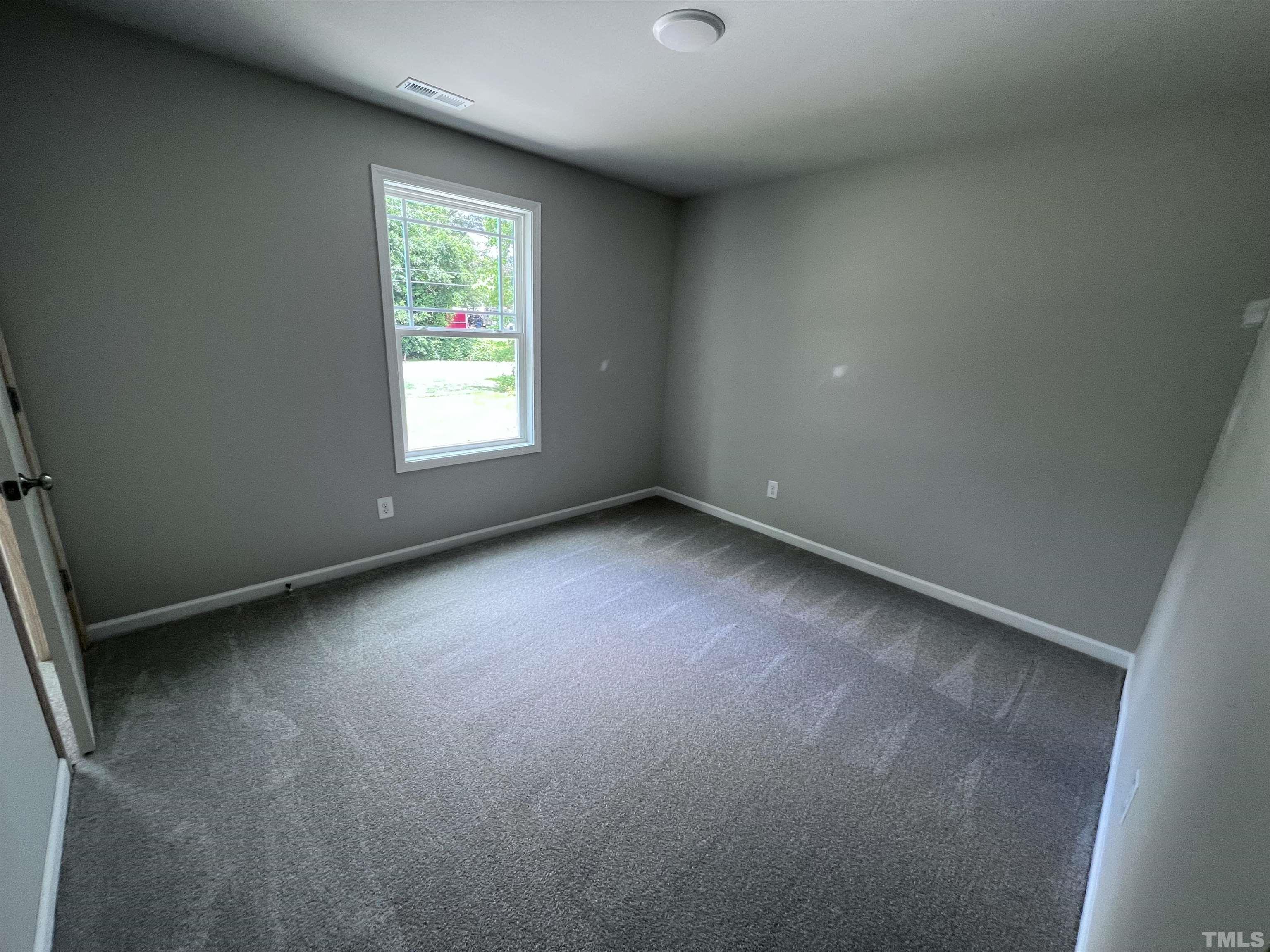 390 Roberts Road Willow Spring, NC 27592 - Photo 16 of 18 an empty room with windows