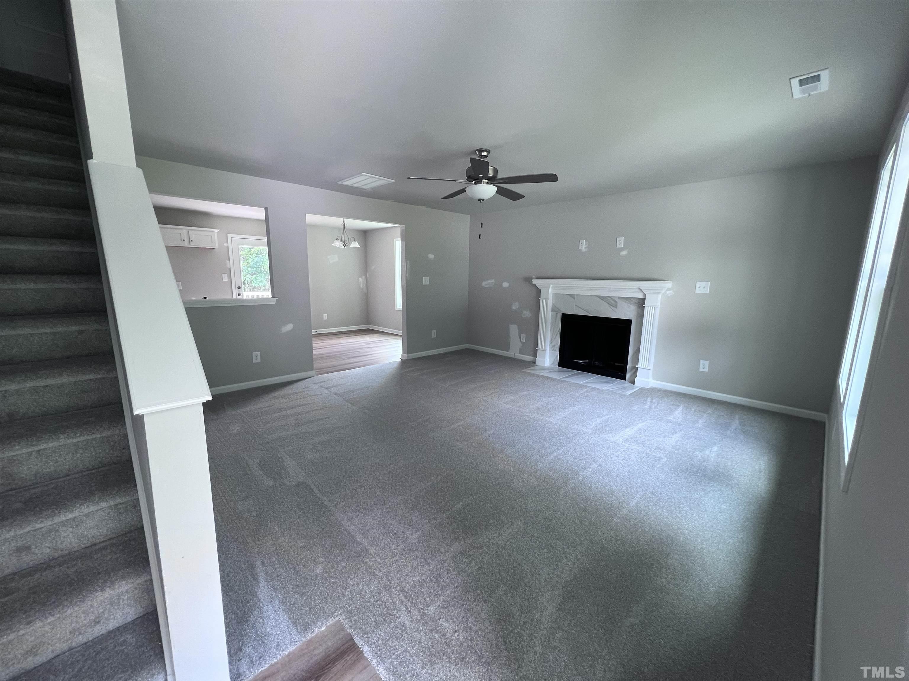 390 Roberts Road Willow Spring, NC 27592 - Photo 4 of 18 wooden floor in an empty room with a fireplace