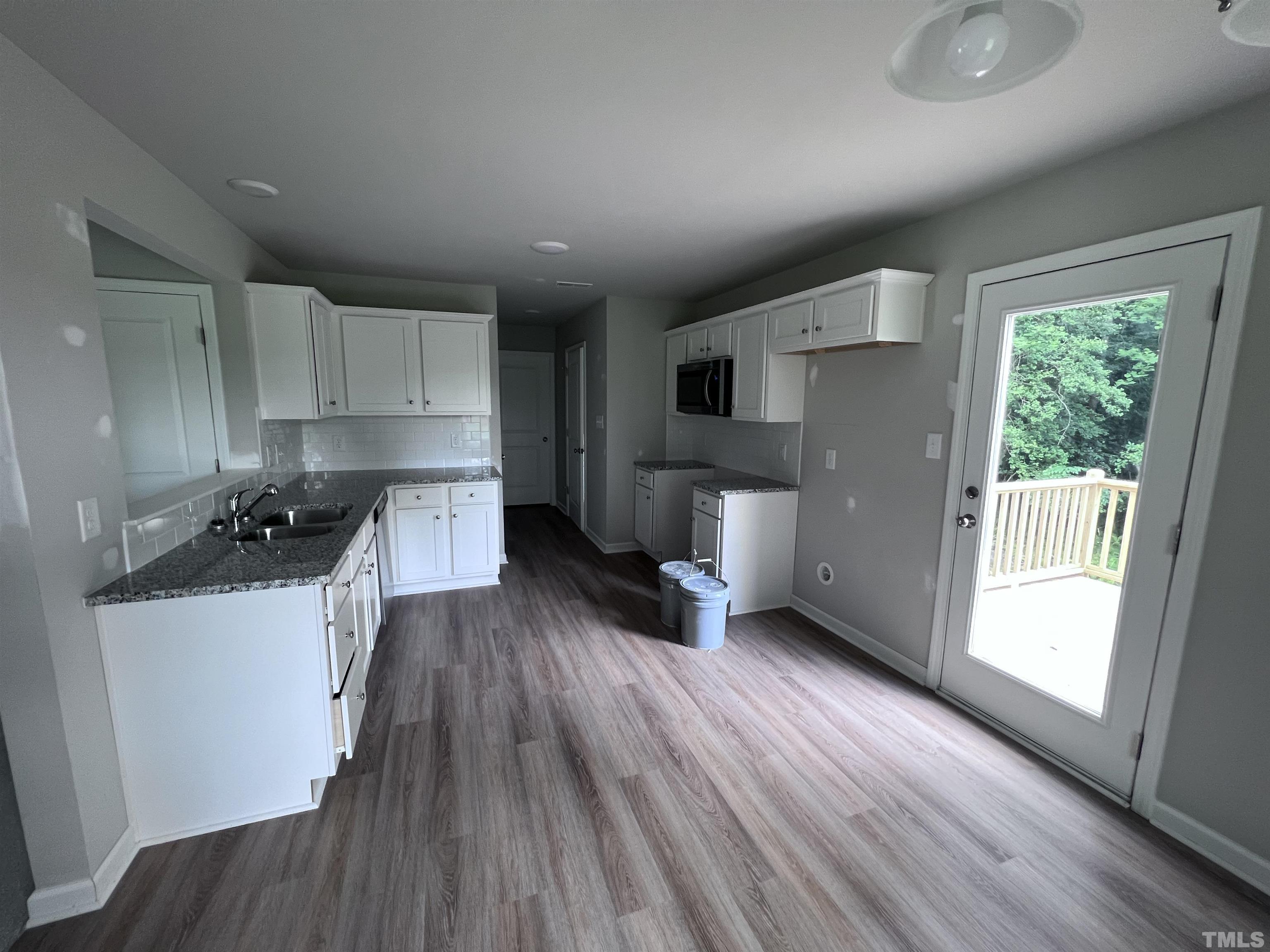 390 Roberts Road Willow Spring, NC 27592 - Photo 6 of 18 a kitchen with sink a microwave a stove and refrigerator