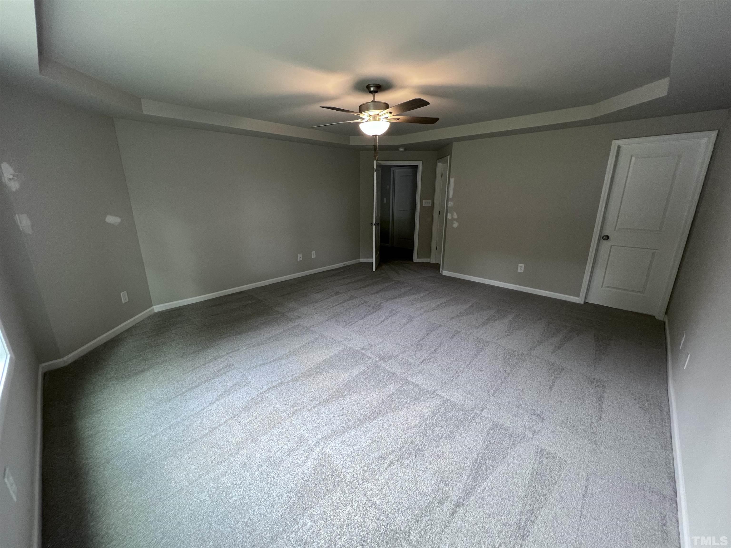 390 Roberts Road Willow Spring, NC 27592 - Photo 10 of 18 a view of an empty room with a chandelier fan