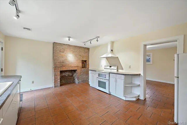 a open kitchen with refrigerator stove and cabinets