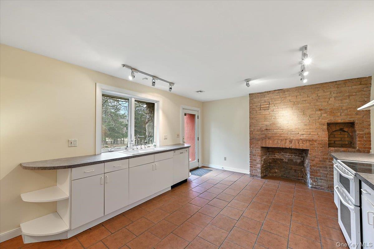 948 Craigville Road Chester, NY 10918 - Photo 15 of 42 a view of an empty room with a fireplace and a window