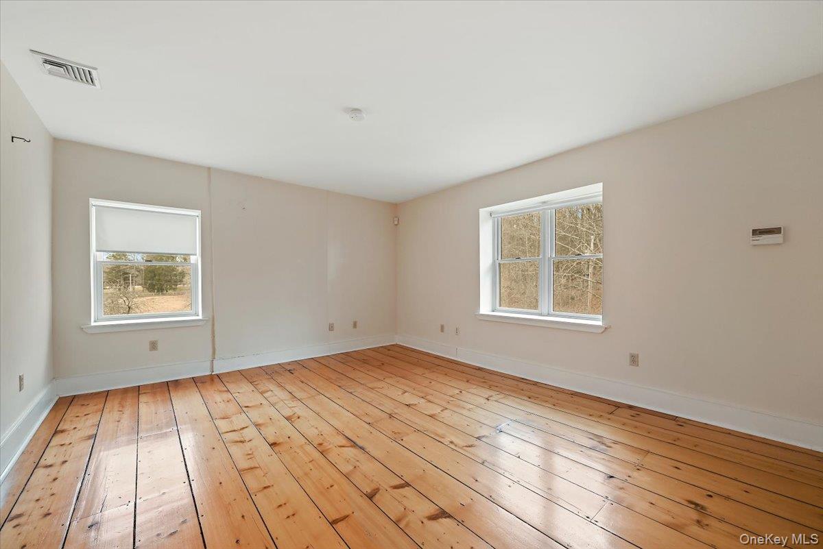 948 Craigville Road Chester, NY 10918 - Photo 22 of 42 a view of an empty room with wooden floor and a window