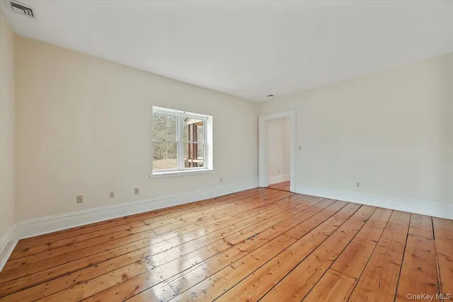 a view of an empty room and wooden floor