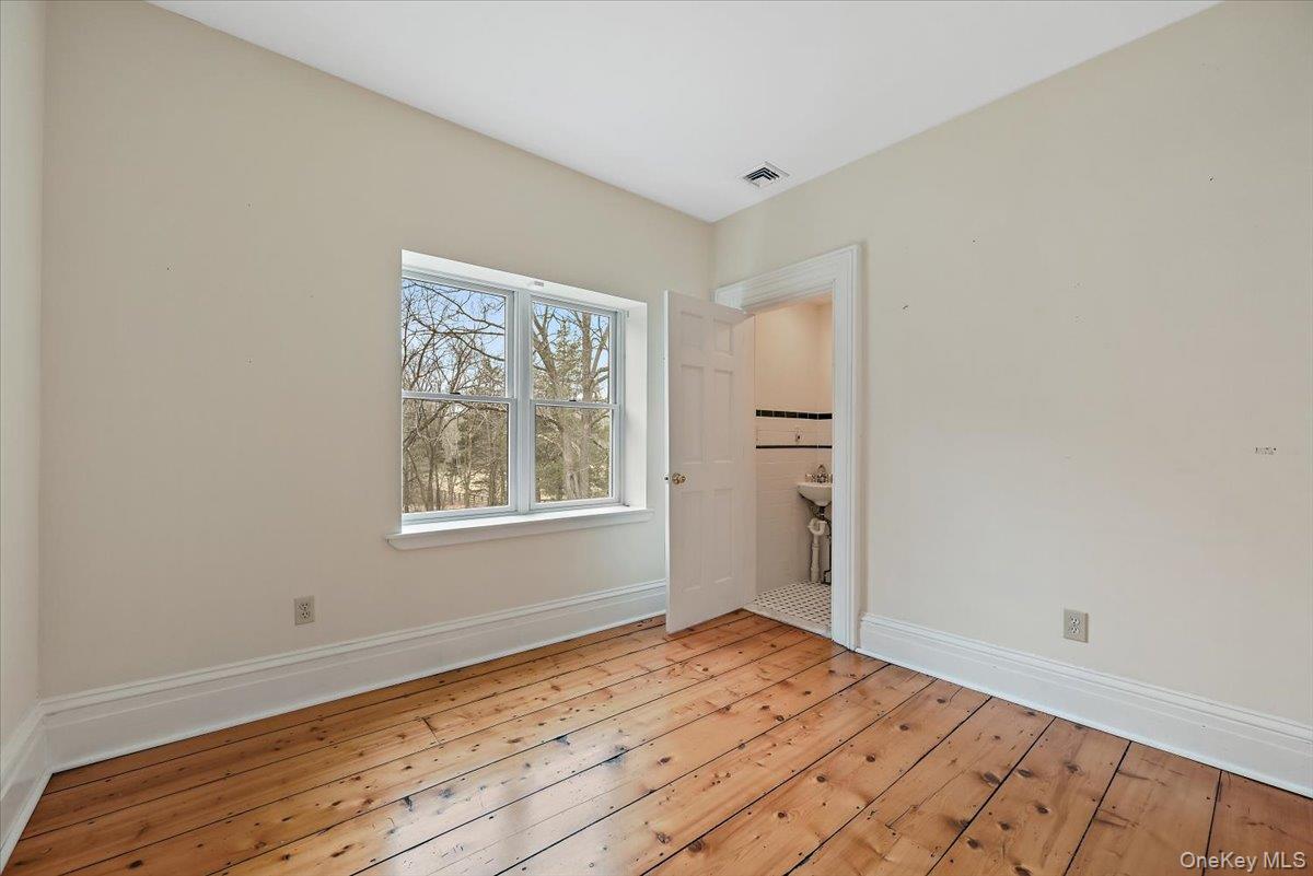 948 Craigville Road Chester, NY 10918 - Photo 29 of 42 a view of empty room with wooden floor and fan
