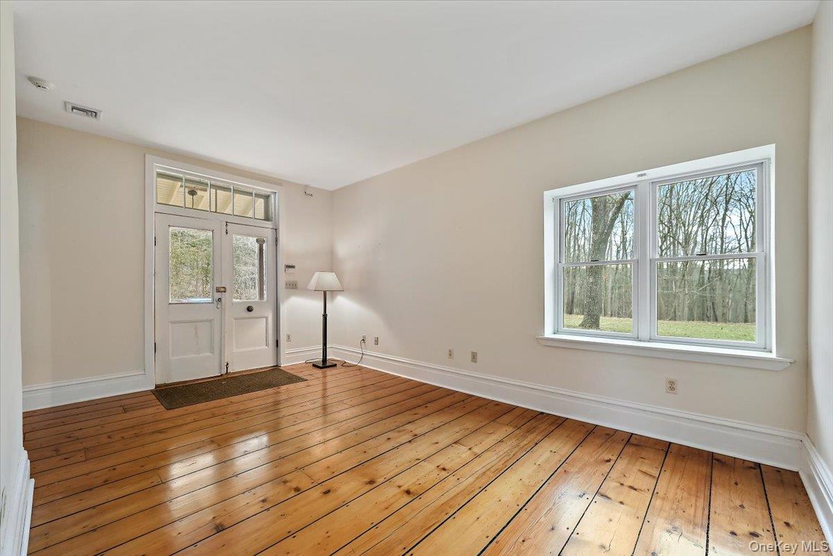 948 Craigville Road Chester, NY 10918 - Photo 7 of 42 a view of wooden floor in an empty room with a window