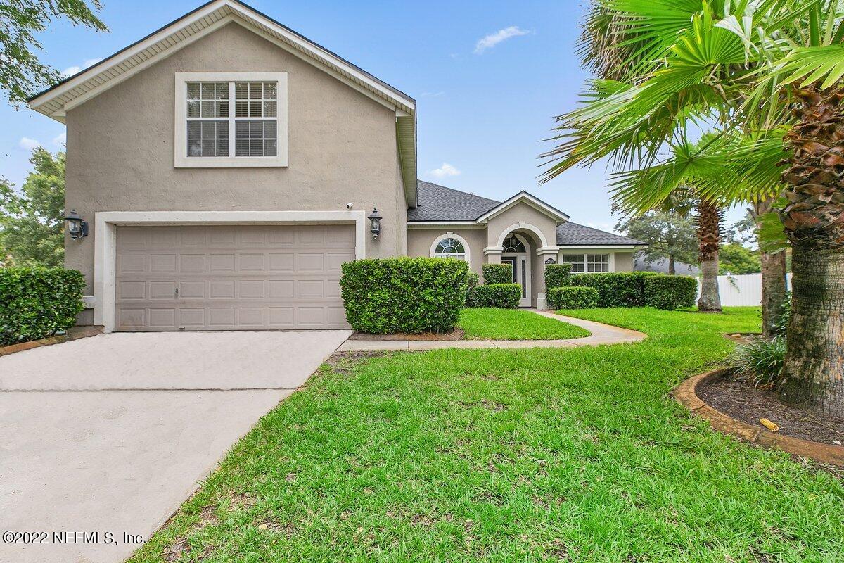 a front view of a house with a yard and garage