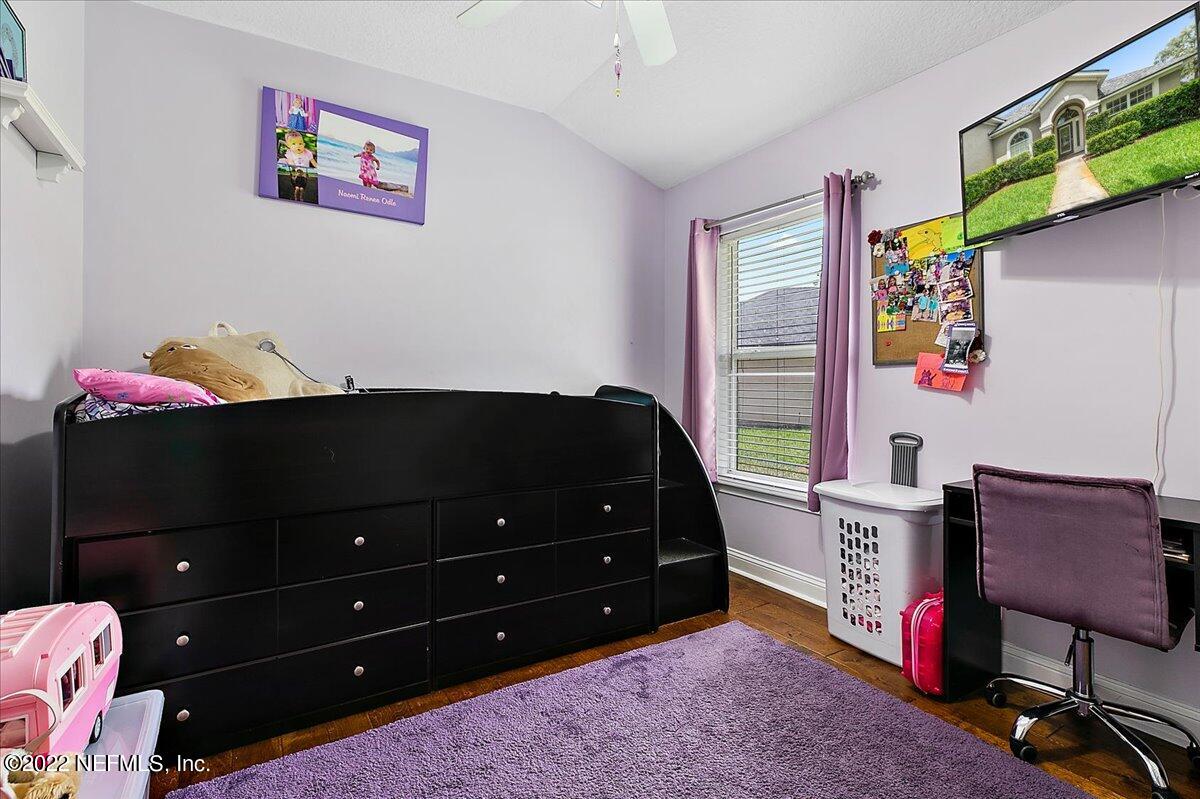 86003 Maple Leaf Place Yulee, FL 32097 - Photo 13 of 27 a bedroom with a dresser and a window