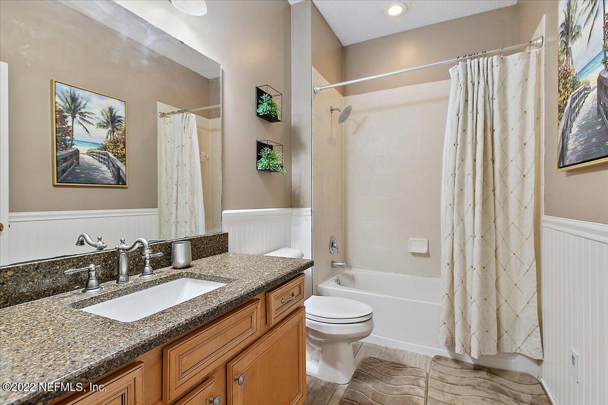 86003 Maple Leaf Place Yulee, FL 32097 - Photo 14 of 27 a bathroom with a granite countertop sink toilet and shower