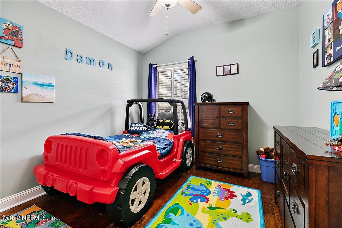 86003 Maple Leaf Place Yulee, FL 32097 - Photo 16 of 27 a bedroom with a bed and wooden floor