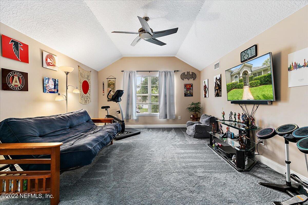 86003 Maple Leaf Place Yulee, FL 32097 - Photo 17 of 27 a living room with furniture gym equipment and a window