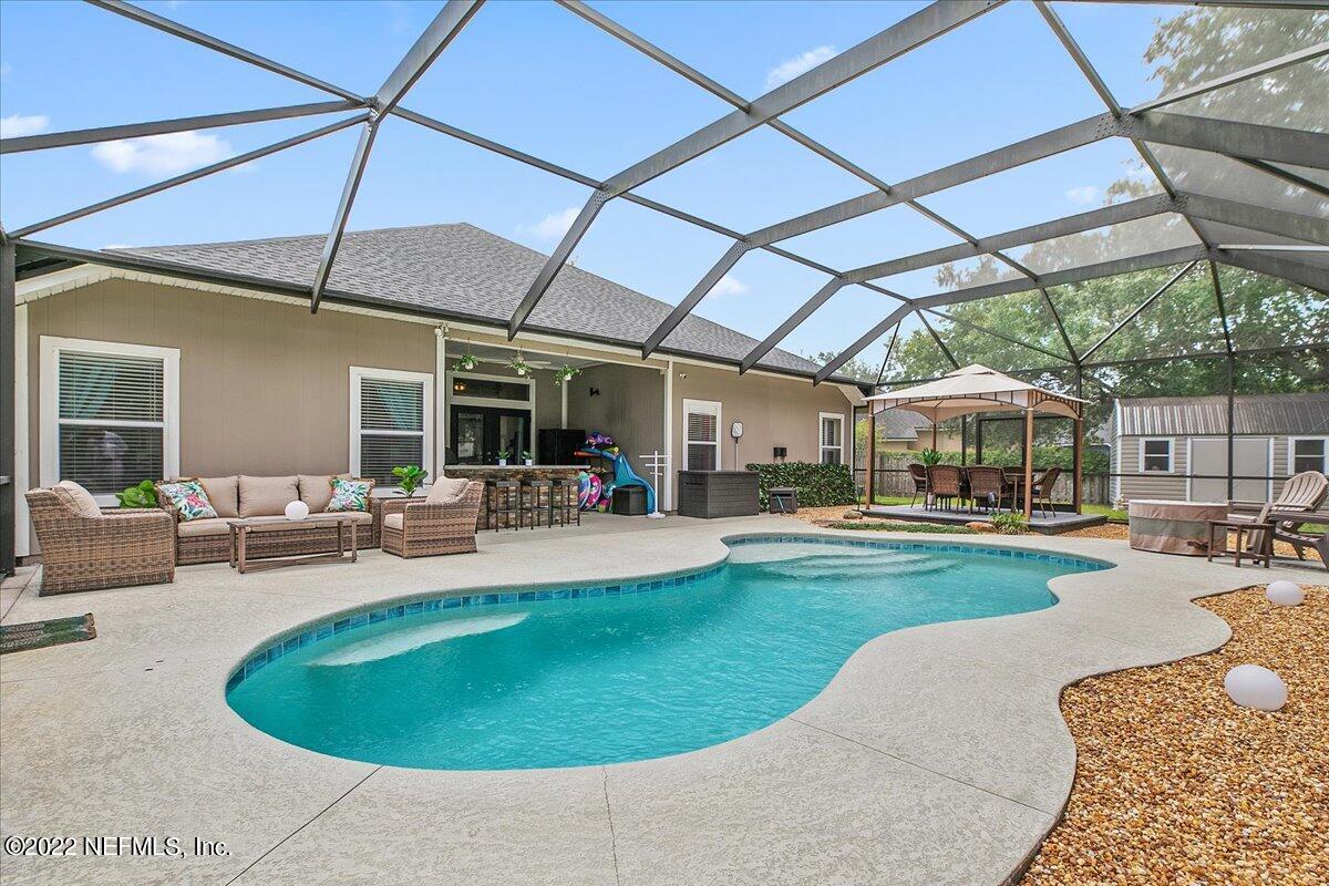 86003 Maple Leaf Place Yulee, FL 32097 - Photo 20 of 27 a view of a swimming pool with a patio