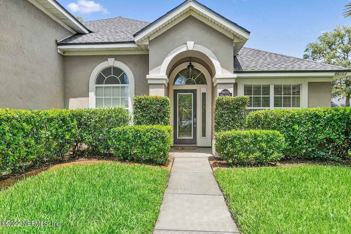 86003 Maple Leaf Place Yulee, FL 32097 - Photo 2 of 27 a front view of a house with a yard