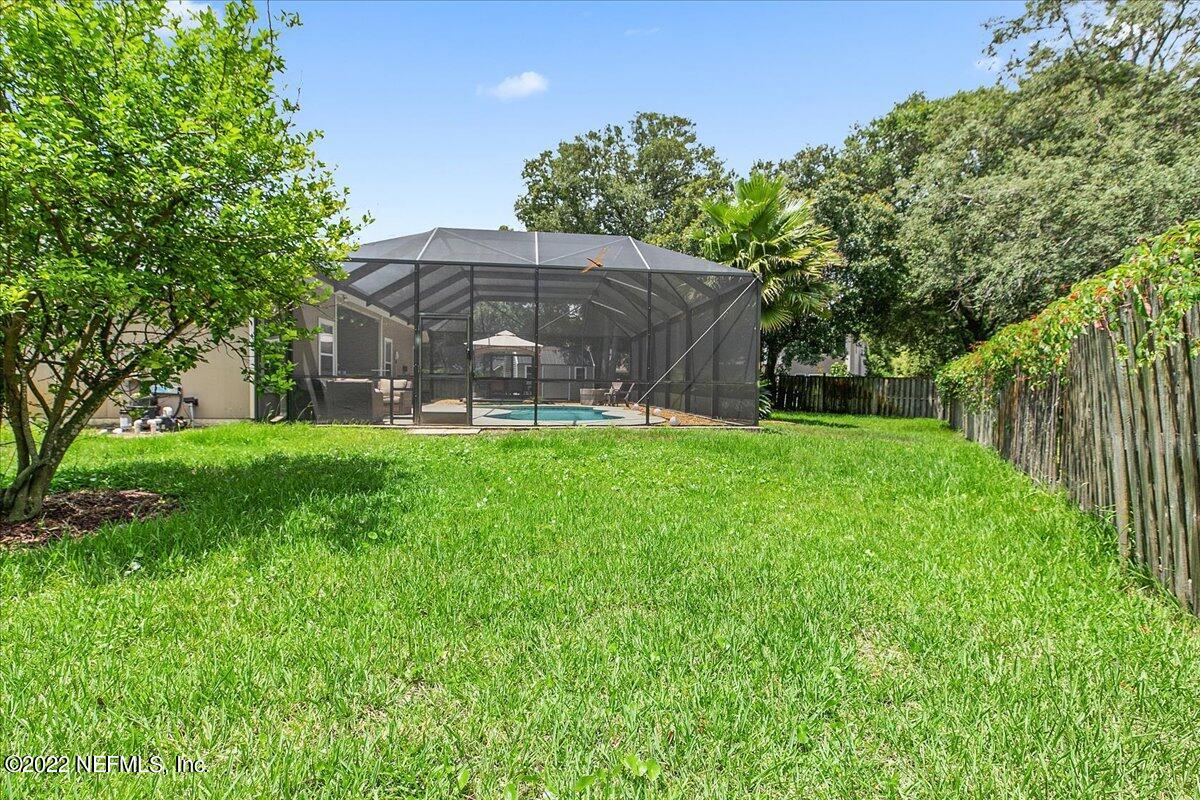 86003 Maple Leaf Place Yulee, FL 32097 - Photo 27 of 27 a view of a chair and table under an umbrella