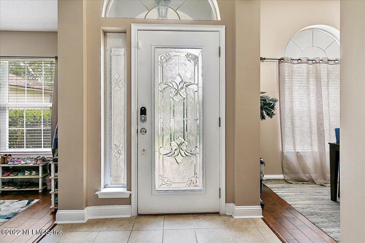 86003 Maple Leaf Place Yulee, FL 32097 - Photo 3 of 27 a view of a hallway with wooden floor windows and livingroom view