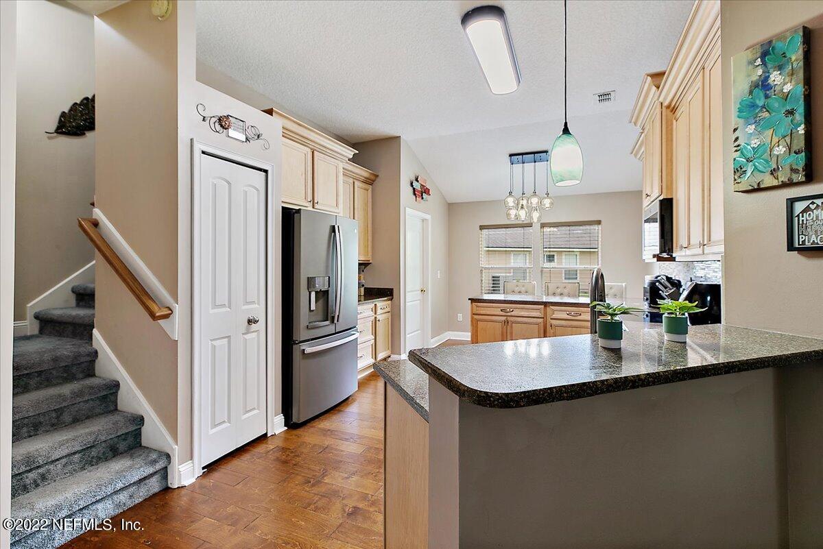 86003 Maple Leaf Place Yulee, FL 32097 - Photo 7 of 27 a kitchen with stainless steel appliances granite countertop a refrigerator and a sink