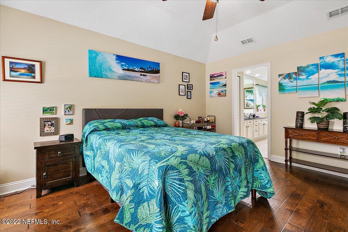 86003 Maple Leaf Place Yulee, FL 32097 - Photo 10 of 27 a bedroom with a bed and a view of kitchen