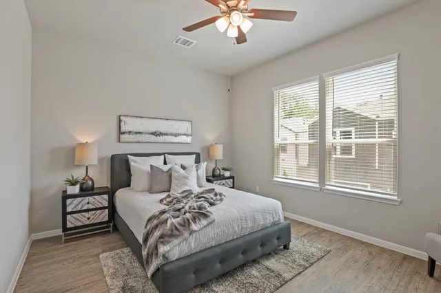 a bedroom with a large bed and a window