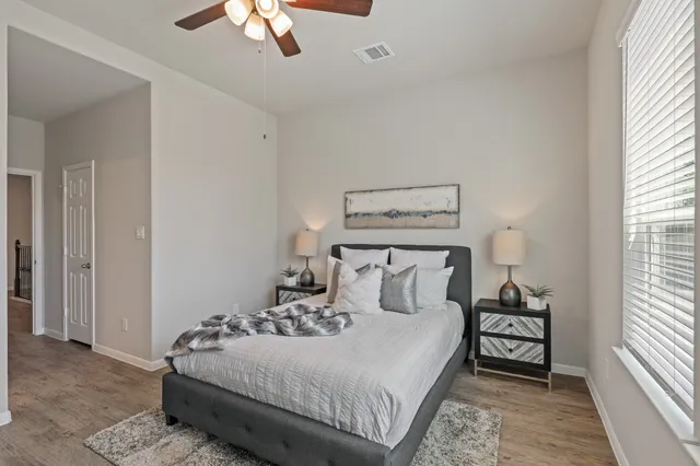 a bedroom with a bed and a chandelier