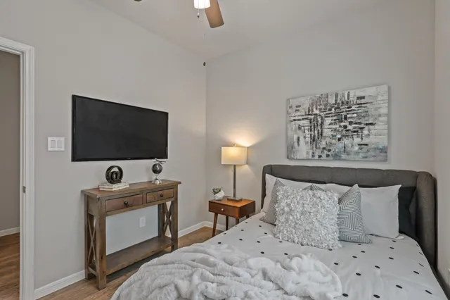 a bedroom with a bed and a flat screen tv