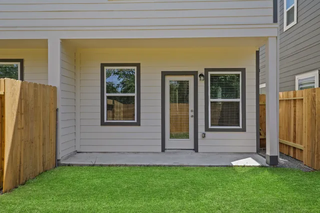 a view of front door of house with a yard
