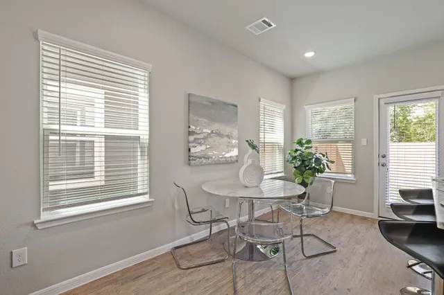 a dining room with furniture and window