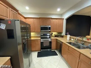 a kitchen with stainless steel appliances a refrigerator sink and stove