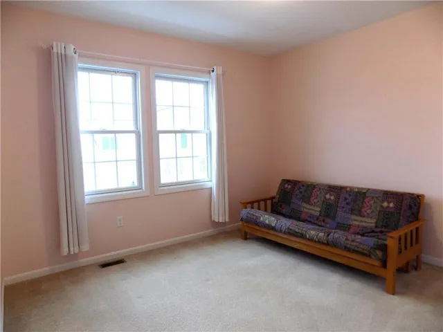 a living room with furniture and a dresser