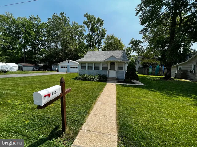 a front view of a house with a yard table and chairs