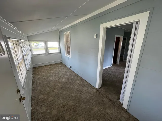 a view of a room with wooden ceiling