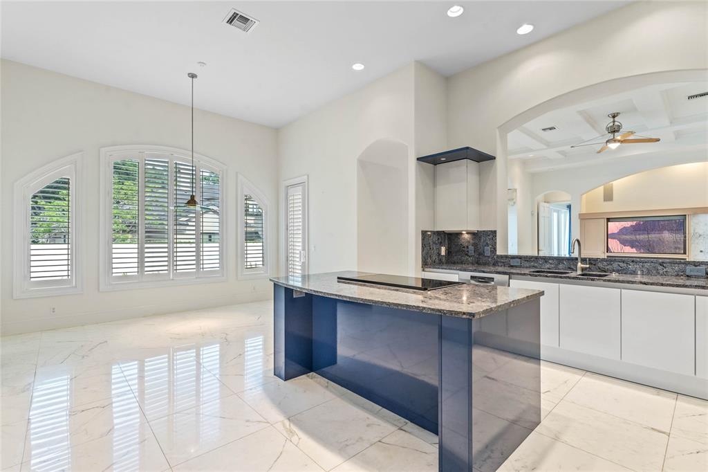 9701 Lake Isleworth Court Windermere, FL 34786 - Photo 26 of 31 a kitchen with stainless steel appliances granite countertop a stove a sink a oven and a refrigerator