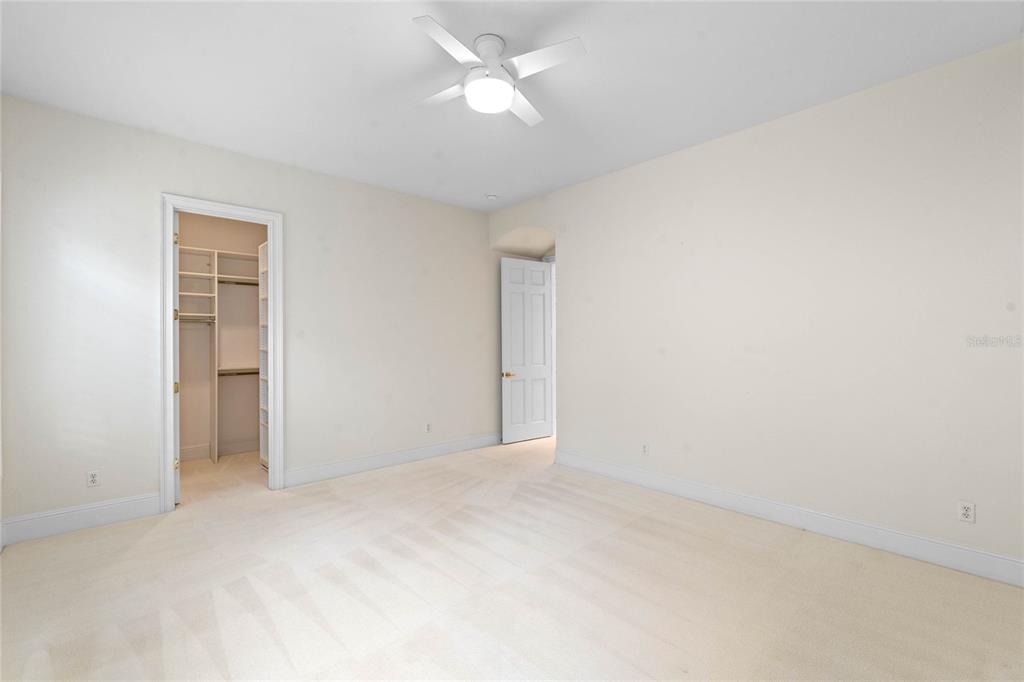 9701 Lake Isleworth Court Windermere, FL 34786 - Photo 4 of 31 an empty room with a ceiling fan and a window