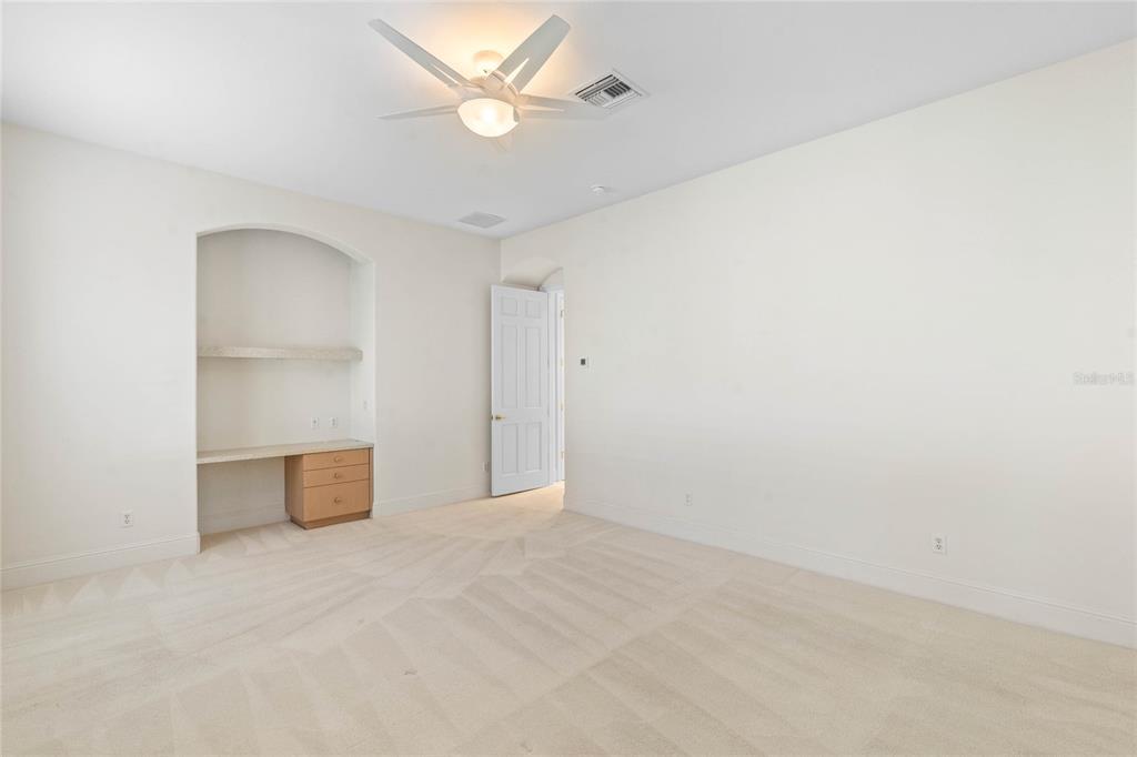 9701 Lake Isleworth Court Windermere, FL 34786 - Photo 6 of 31 an empty room with a ceiling fan and a window