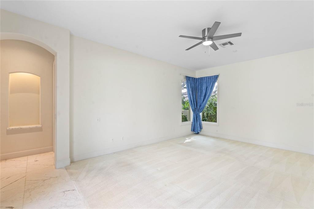 9701 Lake Isleworth Court Windermere, FL 34786 - Photo 9 of 31 a view of a livingroom with a ceiling fan and window