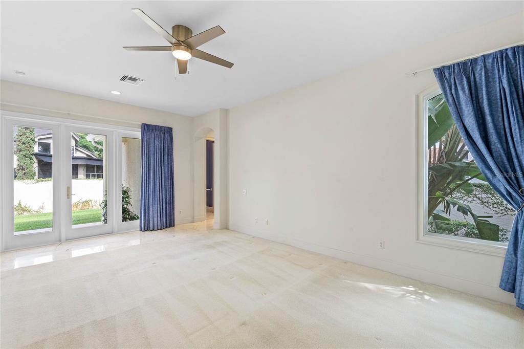 9701 Lake Isleworth Court Windermere, FL 34786 - Photo 10 of 31 a view of a livingroom with a ceiling fan and window