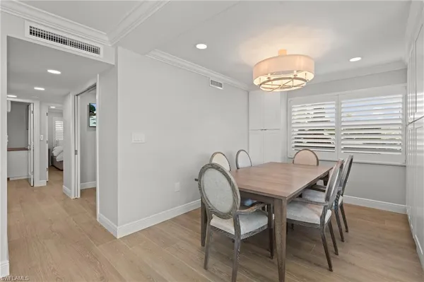 a view of a dining room with furniture and wooden floor