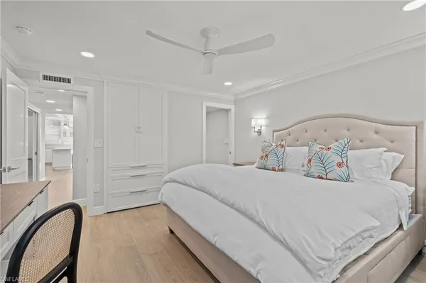 a bedroom with a bed and a mirror