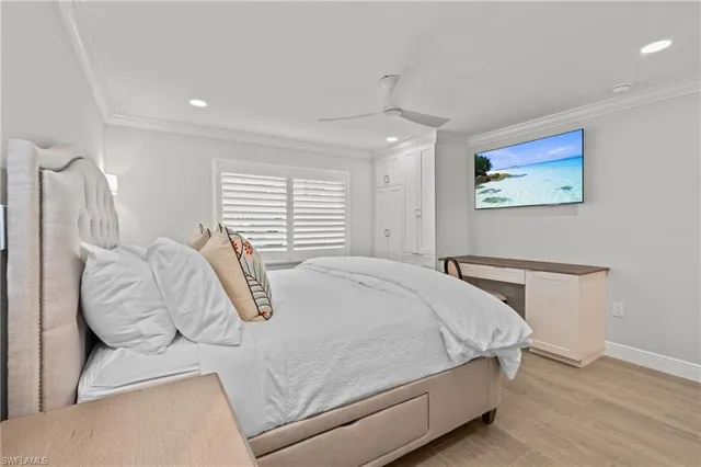 a bedroom with a bed and a painting on the wall