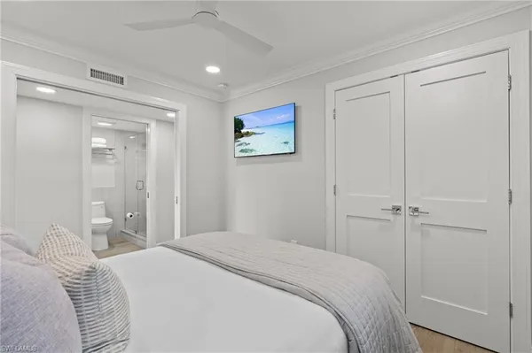 a bedroom with a bed and a painting on the wall