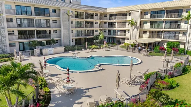 a view of a house with swimming pool and sitting area