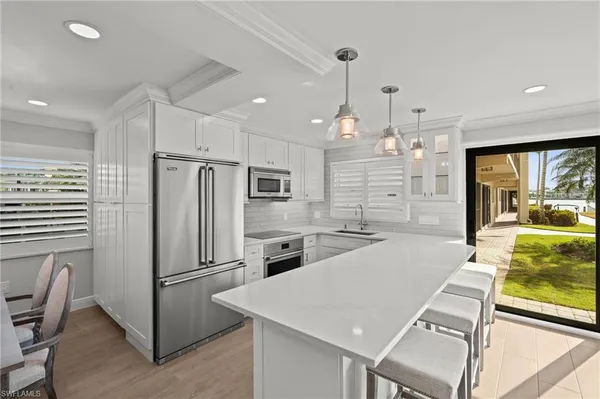 a kitchen with stainless steel appliances a refrigerator sink and stove
