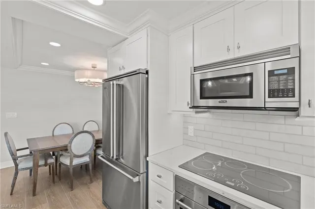 a kitchen with a refrigerator and a table