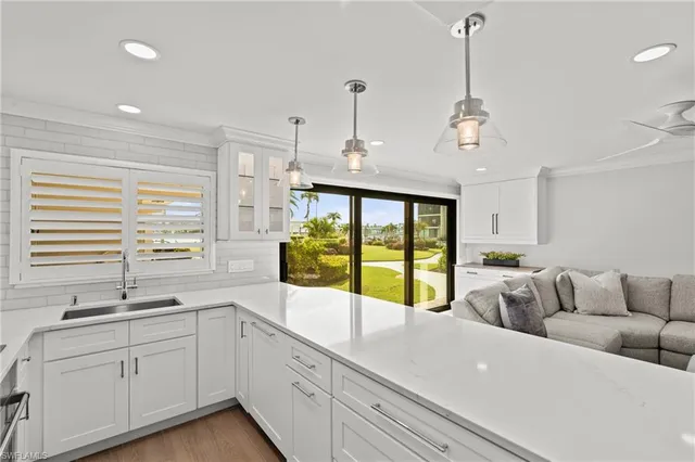 a spacious bedroom with a large bed and a chandelier