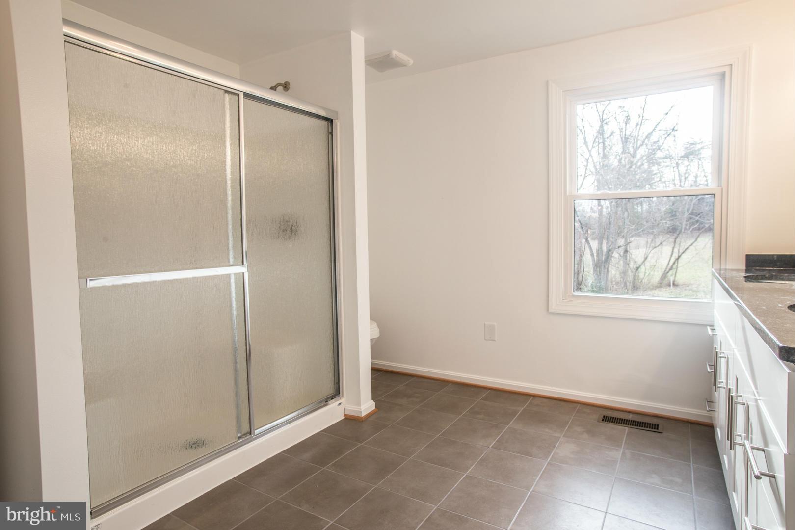 1995 Sixes Road Prince Frederick, MD 20678 - Photo 11 of 30 a bathroom with a glass shower door