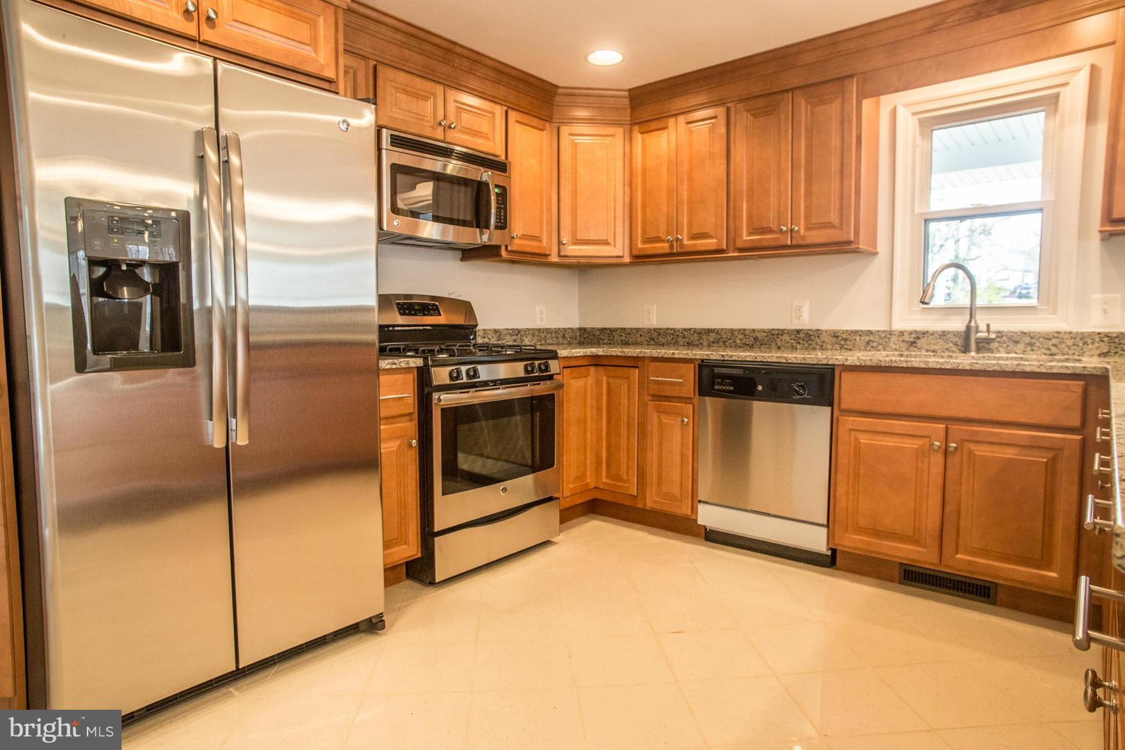 1995 Sixes Road Prince Frederick, MD 20678 - Photo 3 of 30 a kitchen with stainless steel appliances granite countertop a stove a sink and a microwave
