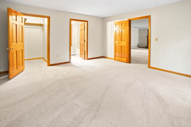 an empty room with windows and closet