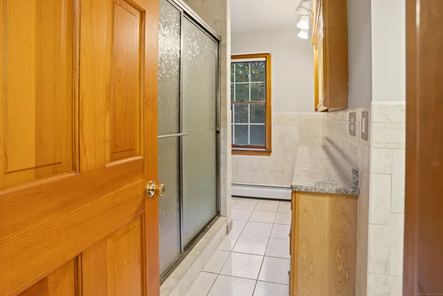 a bathroom with a toilet and a shower